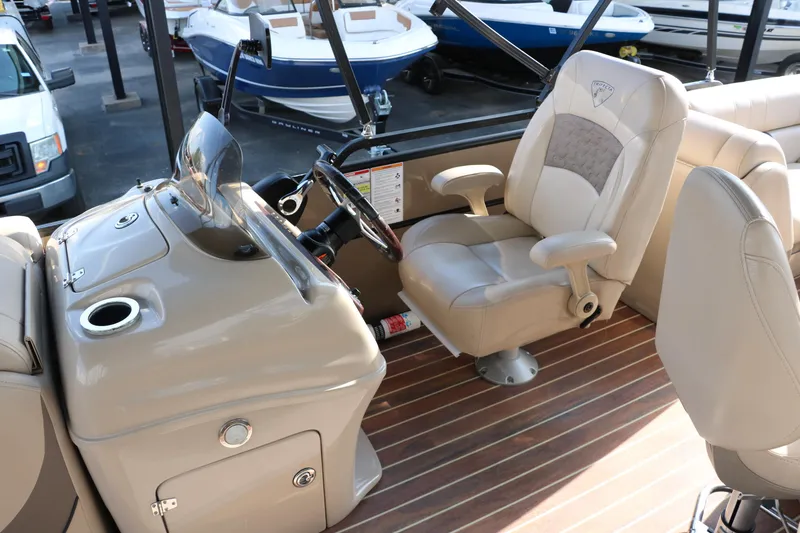 Slide: The Image of 2018 Trifecta 23 RFE boat interior with beige captain's chair and control console. - 29