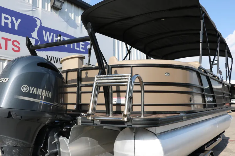Slide: The Image of 2018 Trifecta 23 RFE pontoon boat with Yamaha engine and canopy, docked outdoors. - 3