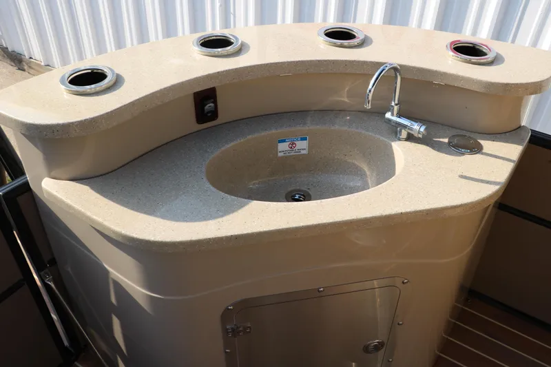 Slide: The Image of Outdoor sink on a 2018 Trifecta 23 RFE boat with cup holders and faucet. - 31