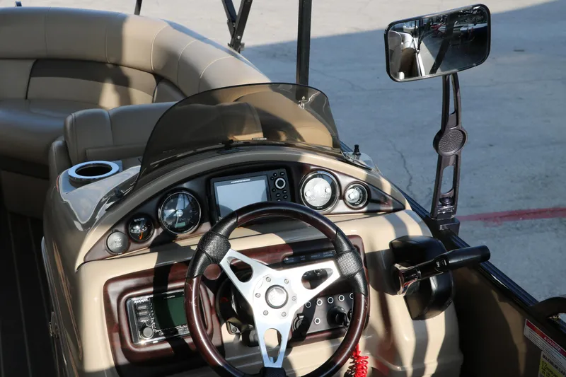 Slide: The Image of 2018 Trifecta 23 RFE boat dashboard with steering wheel and control panel. - 39