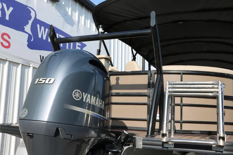 Slide: The Image of 2018 Trifecta 23 RFE boat with Yamaha 150 engine, docked near a building. - 4