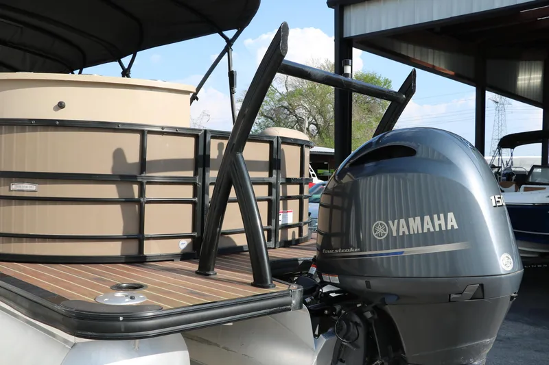 Slide: The Image of 2018 Trifecta 23 RFE pontoon boat with Yamaha outboard motor in marina setting. - 5