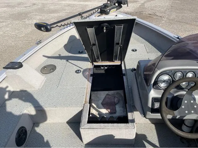 Slide: The Image of 2015 G3 V172C boat interior with open storage compartment and steering console. - 10