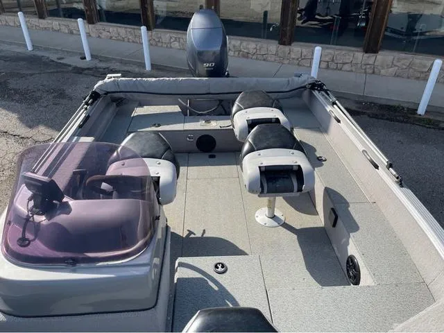 Slide: The Image of 2015 G3 V172C boat interior with seating and motor, docked outdoors. - 11