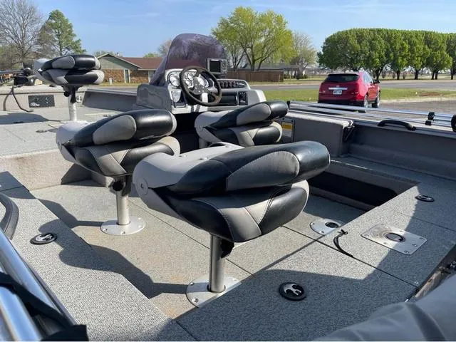 Slide: The Image of 2015 G3 V172C boat interior with black and gray seating, steering console, and outdoor setting. - 6