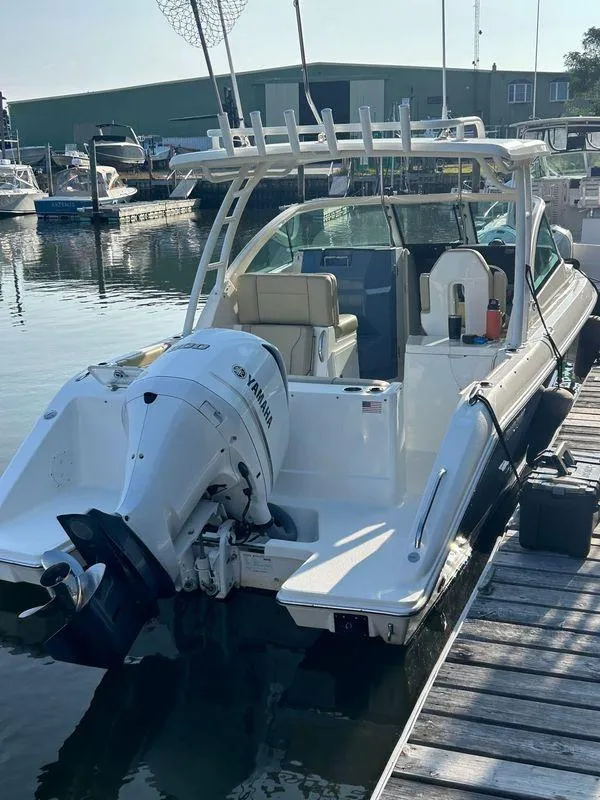 Slide: The Image of 2020 Pursuit DC 235 Dual Console boat docked with Yamaha outboard engine. - 2