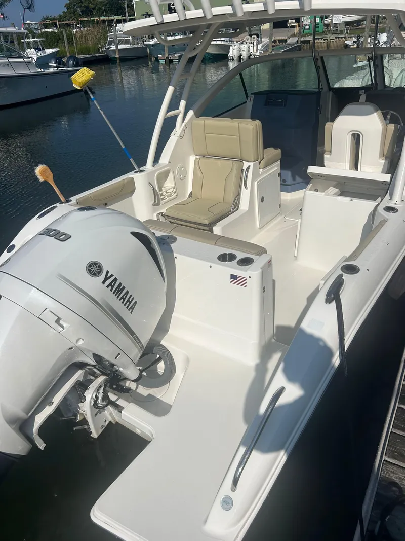 Slide: The Image of 2020 Pursuit DC 235 Dual Console boat with Yamaha engine docked at marina. - 3