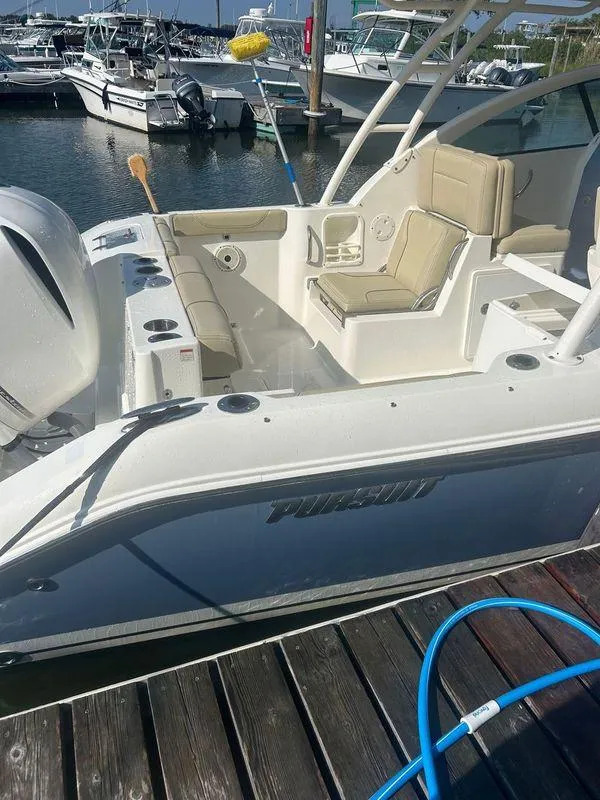 Slide: The Image of 2020 Pursuit DC 235 Dual Console boat docked at marina. - 5
