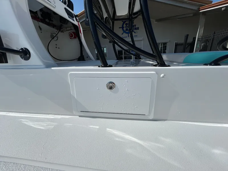 Slide: The Image of 2025 Shallow Sport 22 Sport boat, close-up of storage compartment and console. - 10