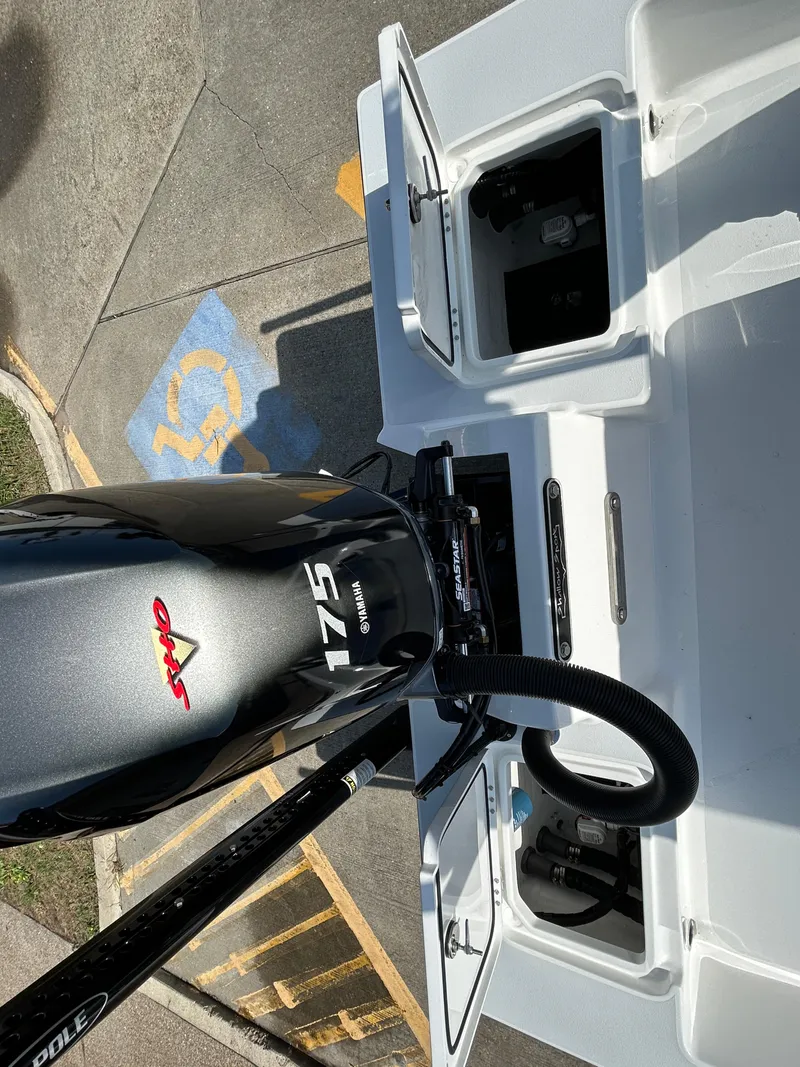 Slide: The Image of 2025 Shallow Sport 22 Sport boat with 175 HP engine, open compartments, and parking area. - 12