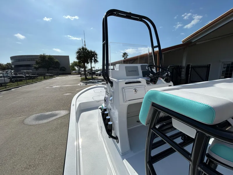 Slide: The Image of 2025 Shallow Sport 22 Sport boat with sleek design and modern console, parked outdoors. - 16