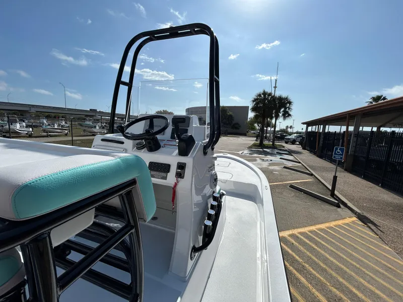 Slide: The Image of 2025 Shallow Sport 22 Sport boat with sleek design, parked in sunny marina. - 17