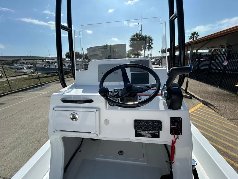 Slide: The Image of 2025 Shallow Sport 22 Sport boat console with steering wheel and control panel. - 18