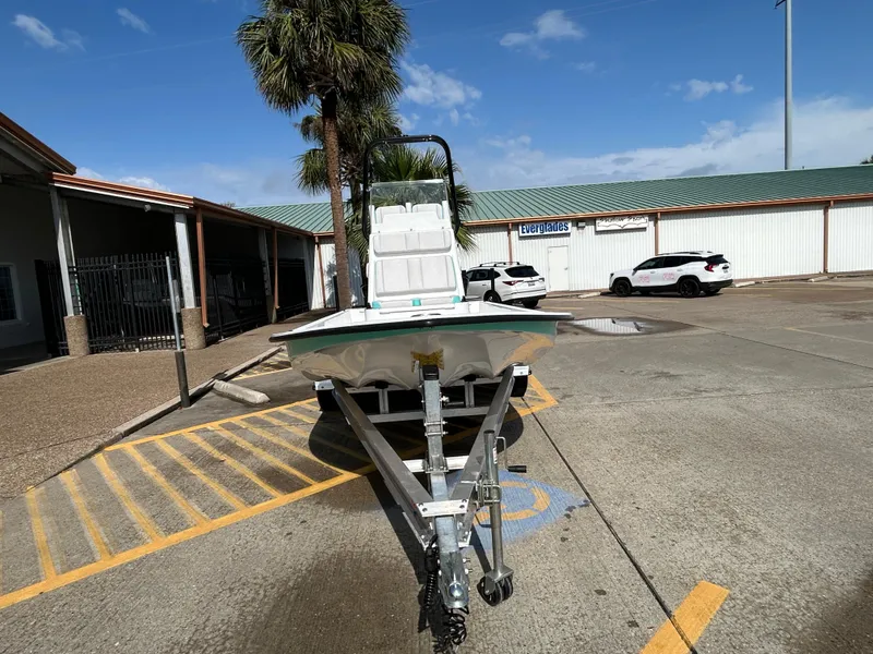 Slide: The Image of 2025 Shallow Sport 22 Sport boat on trailer in parking lot, sunny day. - 2