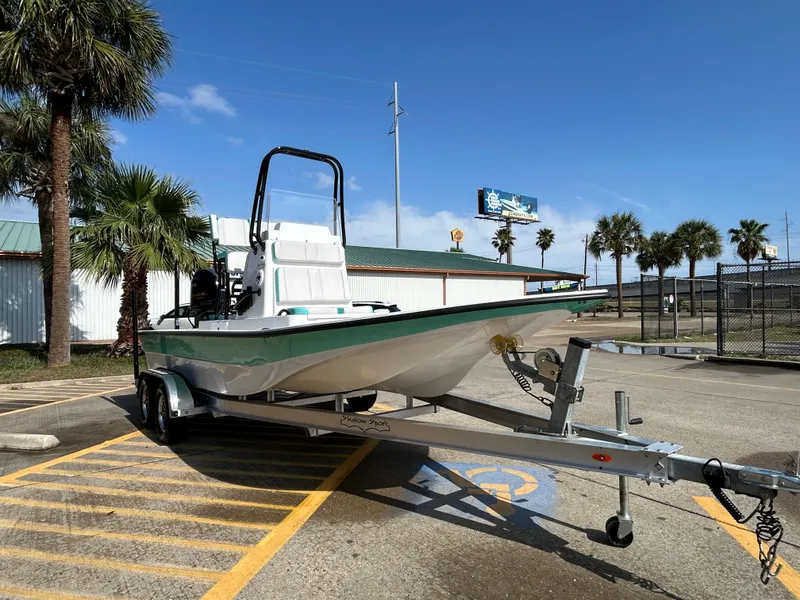 Slide: The Image of 2025 Shallow Sport 22 Sport boat on trailer in sunny parking lot. - 3