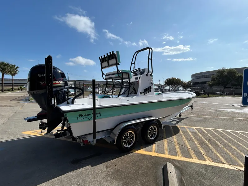 Slide: The Image of 2025 Shallow Sport 22 Sport boat on trailer in sunny parking lot. - 5
