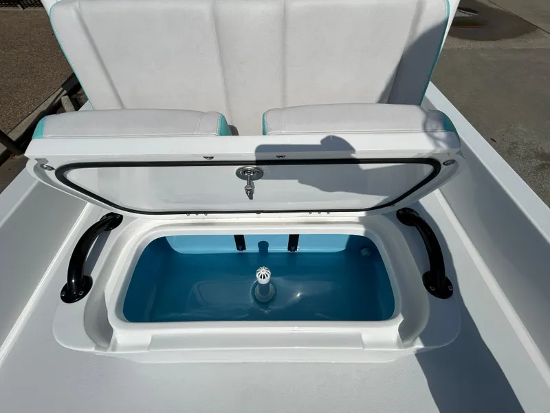 Slide: The Image of 2025 Shallow Sport 22 Sport boat with open storage compartment and cushioned seating. - 9