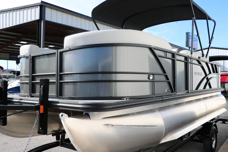 Slide: The Image of 2025 Sylvan Mirage 820 Party Fish Premium Pontoon, sleek design, docked under a canopy. - 10