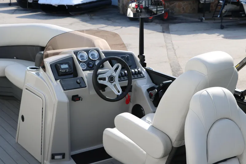 Slide: The Image of 2025 Sylvan Mirage 820 Party Fish Premium Pontoon cockpit with steering wheel and controls. - 28