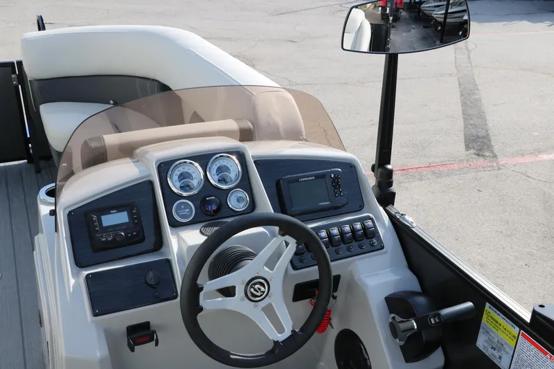 Slide: The Image of 2025 Sylvan Mirage 820 Party Fish Premium Pontoon dashboard with steering wheel and controls. - 34