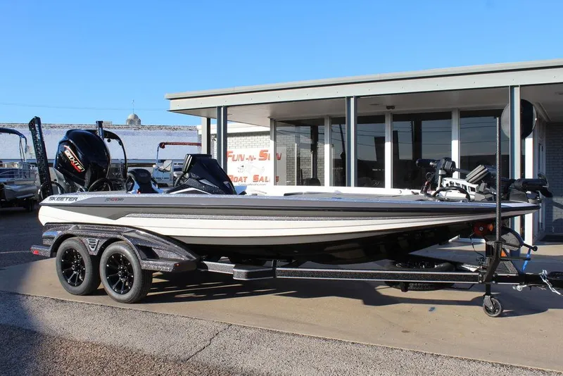 Slide: The Image of 2025 Skeeter FXR20L boat on trailer, parked outside a building. - 1