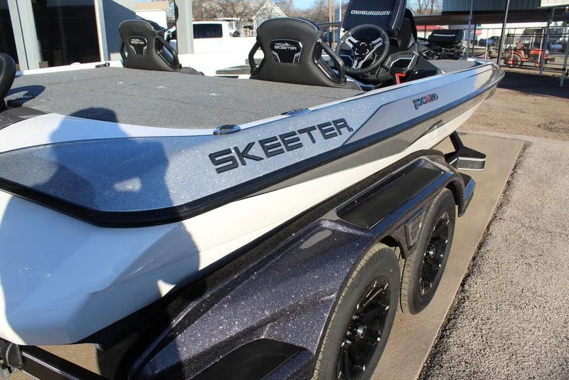 Slide: The Image of 2025 Skeeter FXR20L boat on trailer, showcasing sleek design and modern features. - 11