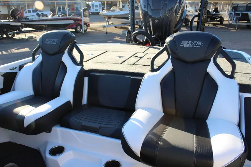 Slide: The Image of 2025 Skeeter FXR20L boat seats, black and white design, in a showroom setting. - 16