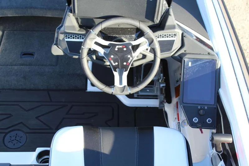 Slide: The Image of 2025 Skeeter FXR20L boat cockpit with steering wheel and digital display. - 20