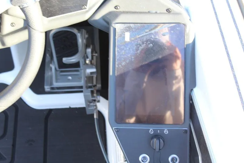 Slide: The Image of 2025 Skeeter FXR20L boat dashboard with steering wheel and control panel. - 21