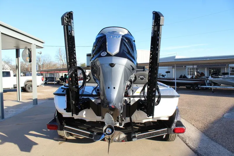 Slide: The Image of 2025 Skeeter FXR20L boat with powerful outboard motor, parked on a trailer. - 4