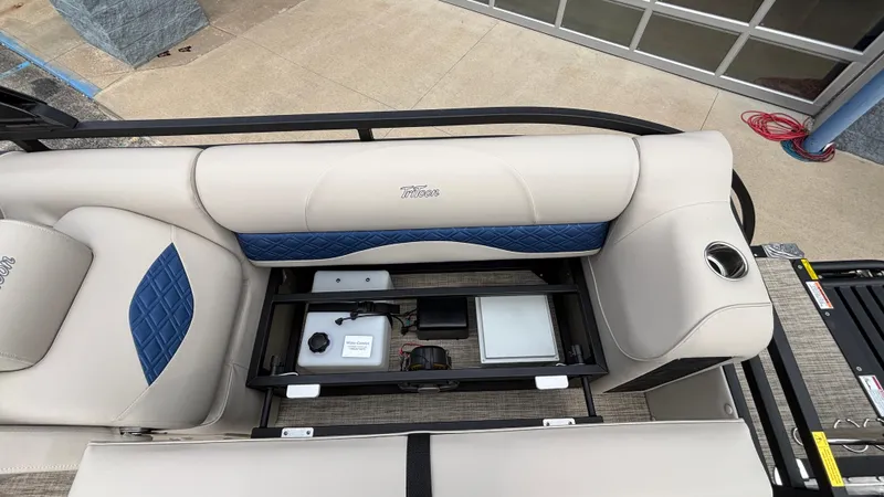 Slide: The Image of 2025 JC Neptoon 25TT Sport boat interior with storage compartment open, showcasing seating and cup holder. - 13