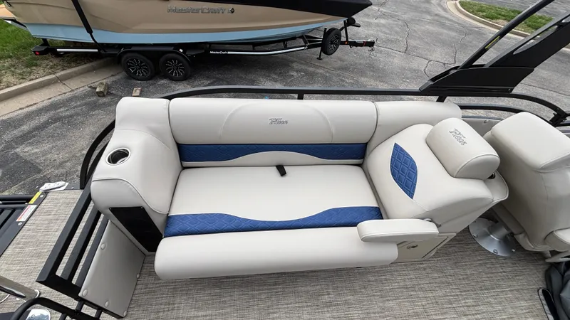Slide: The Image of Luxurious seating on 2025 JC Neptoon 25TT Sport pontoon boat, featuring blue and white upholstery. - 14