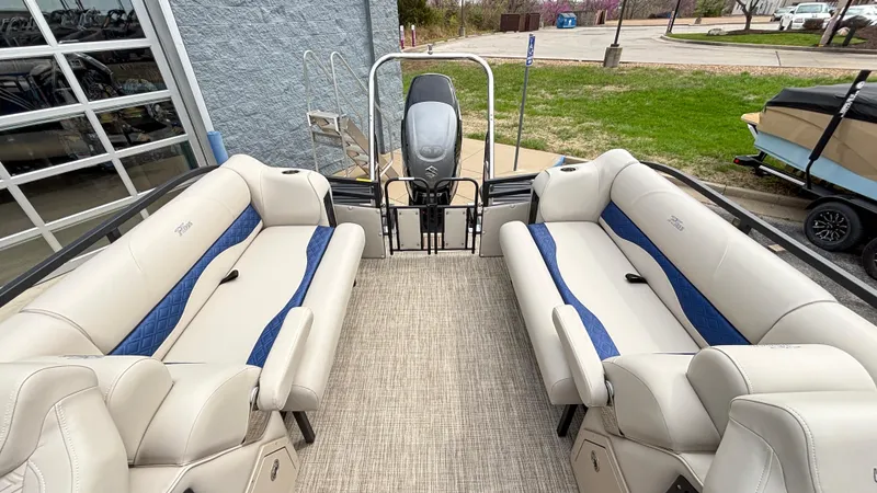 Slide: The Image of 2025 JC Neptoon 25TT Sport pontoon boat interior with beige and blue seating. - 16
