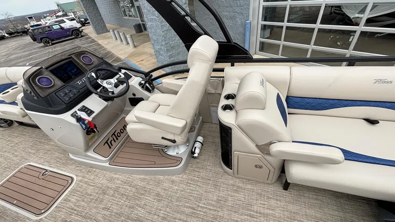 Slide: The Image of 2025 JC Neptoon 25TT Sport pontoon boat interior with helm and seating area. - 19