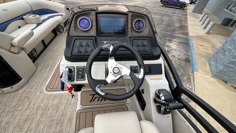 Slide: The Image of 2025 JC Neptoon 25TT Sport boat dashboard with steering wheel and control panel. - 23