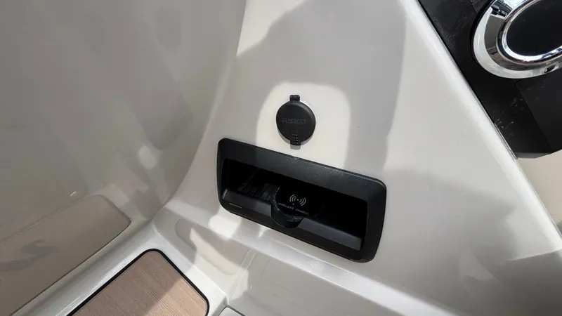 Slide: The Image of 2025 JC Neptoon 25TT Sport interior detail with charging port and storage compartment. - 26