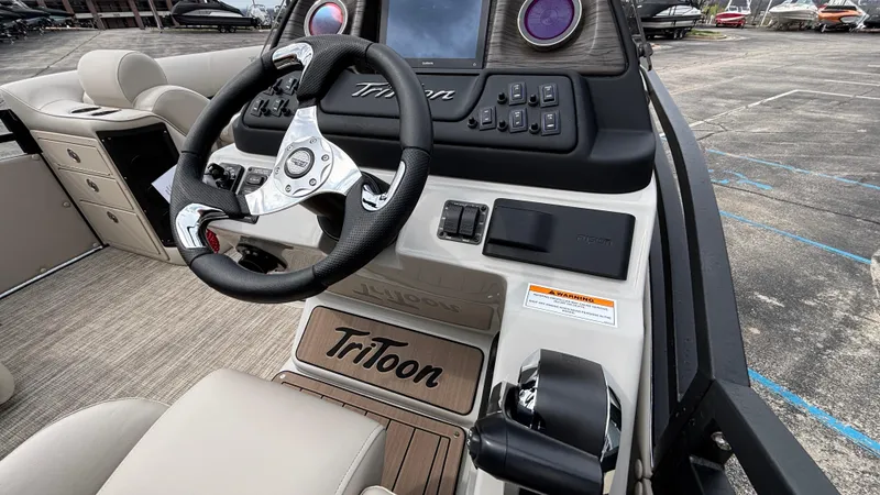 Slide: The Image of 2025 JC Neptoon 25TT Sport boat dashboard with steering wheel and controls. - 27