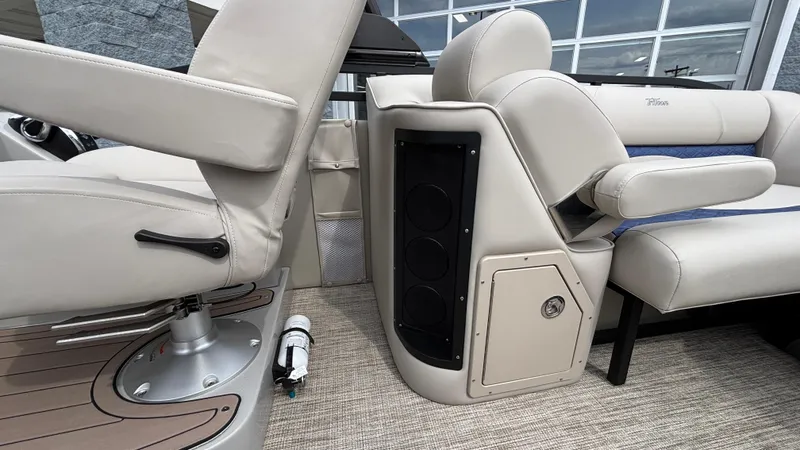Slide: The Image of 2025 JC Neptoon 25TT Sport boat interior with beige seating and speaker system. - 28