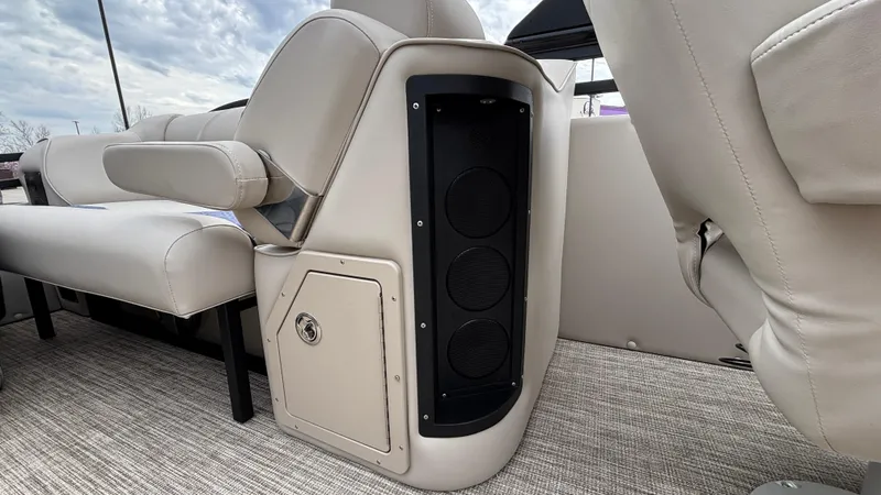 Slide: The Image of Interior of 2025 JC Neptoon 25TT Sport boat with beige seating and built-in speaker system. - 29