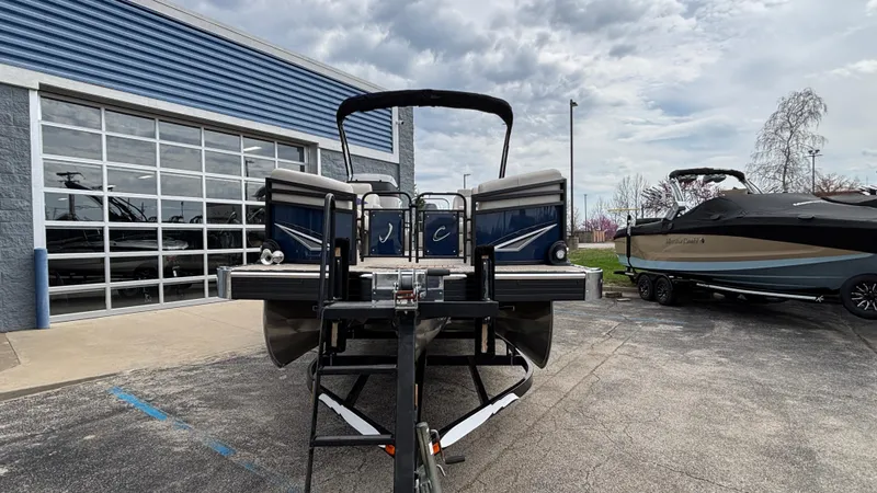 Slide: The Image of 2025 JC Neptoon 25TT Sport pontoon boat on trailer outside dealership. - 3
