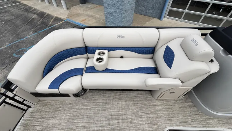 Slide: The Image of Luxurious seating on 2025 JC Neptoon 25TT Sport pontoon boat with blue and white upholstery. - 36