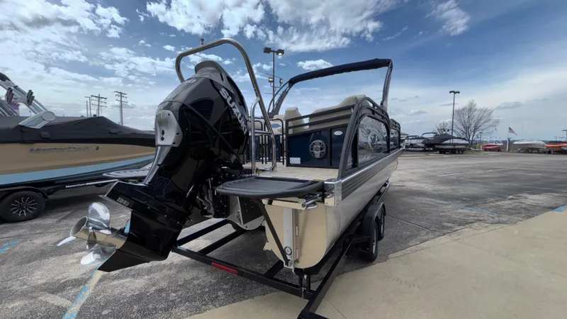 Slide: The Image of 2025 JC Neptoon 25TT Sport boat with powerful outboard motor in a parking lot. - 7