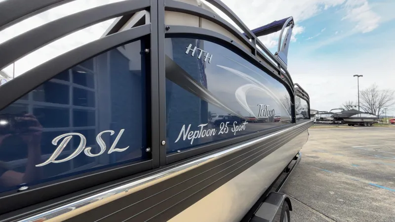 Slide: The Image of 2025 JC Neptoon 25TT Sport boat, sleek design, parked outdoors, side view. - 8