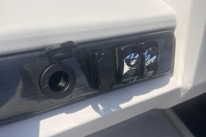 Slide: The Image of 2025 Avalon 2385 LSZ dashboard controls with switches and socket. - 8