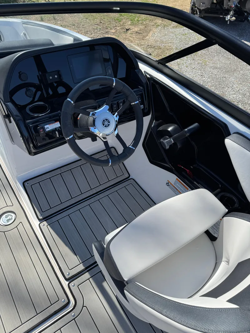 Slide: The Image of 2022 Yamaha Boats 195S cockpit with steering wheel and modern dashboard. - 3