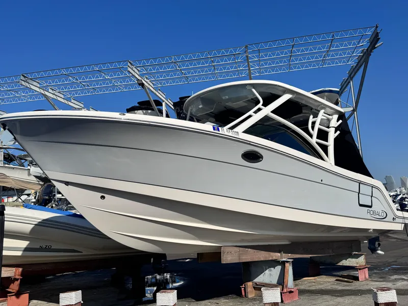 Slide: The Image of 2021 Robalo R317 Dual Console boat on display, elevated on supports. - 21