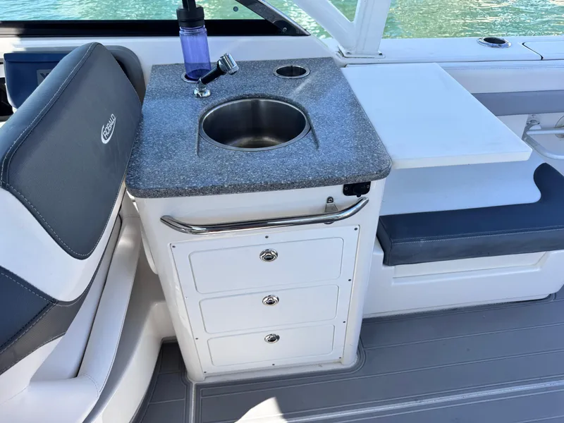 Slide: The Image of 2021 Robalo R317 Dual Console boat interior with sink and storage drawers. - 27
