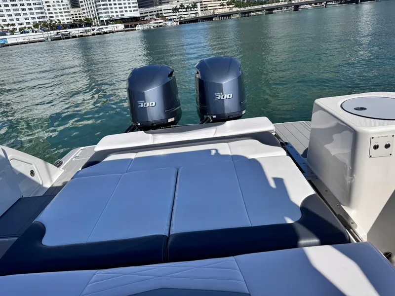 Slide: The Image of 2021 Robalo R317 Dual Console boat with twin 300 horsepower engines on water. - 30