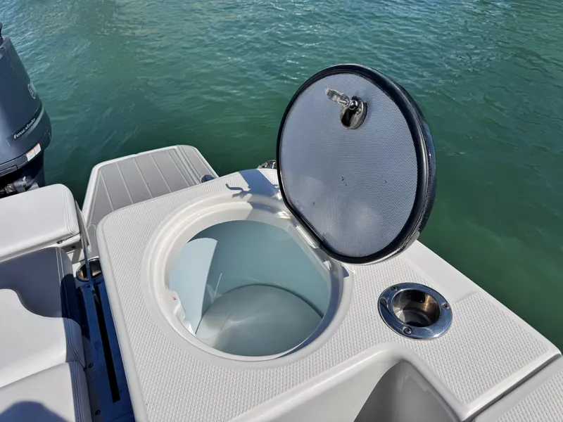 Slide: The Image of 2021 Robalo R317 Dual Console boat with open storage compartment on deck. - 31