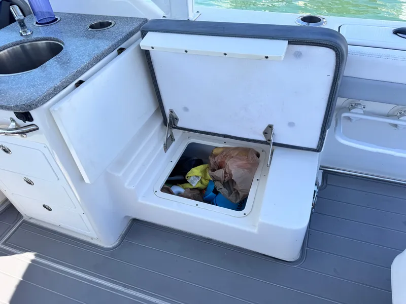 Slide: The Image of 2021 Robalo R317 Dual Console boat with open storage compartment and sink. - 32